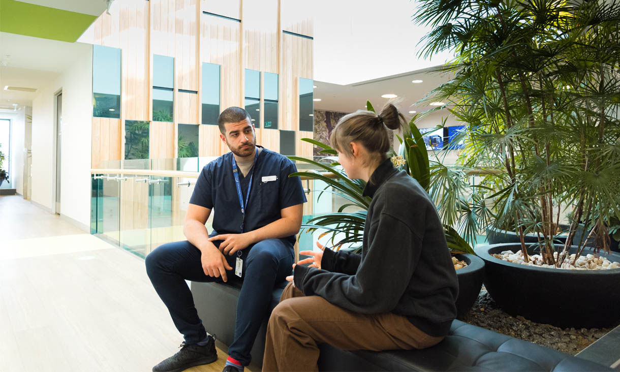 A mental health nurse talks to a patient.